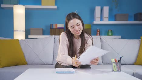 Asian-Young-Woman-Looking-At-Camera-And-Smiling-In-Her-Home-Office.